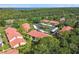 Aerial view of the community, showcasing red-tiled roofs, lush greenery, and convenient parking at 1801 E Lake Rd # 3A, Palm Harbor, FL 34685