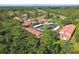 An elevated aerial perspective of the complex, surrounded by lush trees and convenient parking at 1801 E Lake Rd # 3A, Palm Harbor, FL 34685