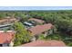 Scenic aerial view showing the condos with mature landscape and lush trees at 1801 E Lake Rd # 3A, Palm Harbor, FL 34685