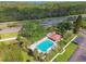 Aerial view of pool, lounge area, green space and freeway in the distance at 1801 E Lake Rd # 3A, Palm Harbor, FL 34685
