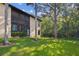 Beautiful backyard with a lush lawn, mature trees and greenery offering a serene and private outdoor space at 1801 E Lake Rd # 3A, Palm Harbor, FL 34685