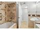 Bathroom featuring a shower and tub with decorative tile, a sink, and access to a closet at 1801 E Lake Rd # 3A, Palm Harbor, FL 34685