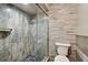 Updated bathroom featuring a modern glass enclosed shower and toilet at 1801 E Lake Rd # 3A, Palm Harbor, FL 34685