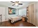 Cozy bedroom features wood flooring, a storage cabinet, and a window providing natural light at 1801 E Lake Rd # 3A, Palm Harbor, FL 34685