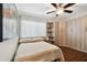 Comfortable bedroom with ample built-in storage, a ceiling fan, and a large window for plenty of natural light at 1801 E Lake Rd # 3A, Palm Harbor, FL 34685