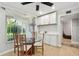 Cozy dining area featuring a glass table, complemented by natural light and built-in white cabinetry at 1801 E Lake Rd # 3A, Palm Harbor, FL 34685
