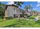 A beautifully landscaped condo complex is highlighted by lush lawns and a variety of trees at 1801 E Lake Rd # 3A, Palm Harbor, FL 34685