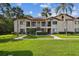 A well-manicured lawn complements this condo building with palm trees, sidewalks, and a neatly landscaped entry at 1801 E Lake Rd # 3A, Palm Harbor, FL 34685