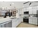 Bright kitchen with white cabinetry, stainless steel appliances, tile flooring and a breakfast bar in view at 1801 E Lake Rd # 3A, Palm Harbor, FL 34685