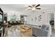 Spacious living room with elegant decor, glossy wood floors, and a ceiling fan for comfortable living at 1801 E Lake Rd # 3A, Palm Harbor, FL 34685
