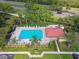 An aerial shot shows the community pool with lounge chairs, trees, and a covered area at 1801 E Lake Rd # 3A, Palm Harbor, FL 34685