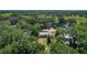 Aerial view showcases the property's wooded surroundings and serene neighborhood setting at 2015 Pleasant Acre Dr, Plant City, FL 33566