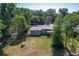 Aerial view of backyard featuring a spacious lawn with mature trees, complemented by a cozy home exterior at 2015 Pleasant Acre Dr, Plant City, FL 33566