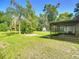 Lush backyard with a view of the screened porch and shed at 2015 Pleasant Acre Dr, Plant City, FL 33566
