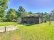 Large backyard with view of home and screened-in porch at 2015 Pleasant Acre Dr, Plant City, FL 33566