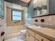 Cozy bathroom with neutral tile, window, and updated sink vanity at 2015 Pleasant Acre Dr, Plant City, FL 33566