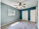 Bedroom features a ceiling fan, wood-look tile flooring, and a light color scheme at 2015 Pleasant Acre Dr, Plant City, FL 33566