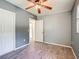 Neutral bedroom boasts closet, ceiling fan, and wood-look tile flooring at 2015 Pleasant Acre Dr, Plant City, FL 33566