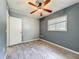 Simple bedroom features a ceiling fan, closet, and wood-look tile floors at 2015 Pleasant Acre Dr, Plant City, FL 33566