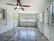 Bonus room featuring tile flooring, ceiling fan, and multiple windows at 2015 Pleasant Acre Dr, Plant City, FL 33566