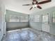 Bonus room with tile flooring, a ceiling fan, and multiple windows at 2015 Pleasant Acre Dr, Plant City, FL 33566