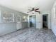 Bonus room with doors to outside, tile flooring, and a ceiling fan at 2015 Pleasant Acre Dr, Plant City, FL 33566