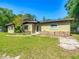 Charming single-story home with a rock detail, mature trees, and a well-maintained lawn at 2015 Pleasant Acre Dr, Plant City, FL 33566