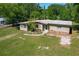 Charming single-story home with a rock detail, mature trees, and a well-maintained lawn at 2015 Pleasant Acre Dr, Plant City, FL 33566