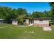 Charming single-story home with a rock detail, mature trees, and a well-maintained lawn at 2015 Pleasant Acre Dr, Plant City, FL 33566