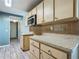 Classic kitchen showcases wood cabinets, tile backsplash, and neutral countertops at 2015 Pleasant Acre Dr, Plant City, FL 33566