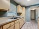 Eat-in kitchen features wood cabinets, wood-look tile flooring, and ample counter space at 2015 Pleasant Acre Dr, Plant City, FL 33566