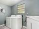 Functional laundry room with washer, dryer, and utility sink at 2015 Pleasant Acre Dr, Plant City, FL 33566