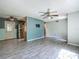 Open living room featuring neutral walls, modern ceiling fan and stylish gray tile flooring at 2015 Pleasant Acre Dr, Plant City, FL 33566