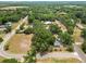 Aerial view of a treed homesite, revealing nearby roads and lush surroundings in a charming neighborhood at 2504 Jim Johnson Rd, Plant City, FL 33566