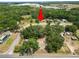 A treed homesite marked with a red arrow, surrounded by lush greenery and roads, complete with neighborhood views at 2504 Jim Johnson Rd, Plant City, FL 33566