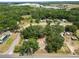 Lush homesite viewed from above, surrounded by lush greenery and other homes, complete with adjacent road access at 2504 Jim Johnson Rd, Plant City, FL 33566