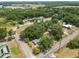 An aerial view of a tree-covered lot, situated on a corner lot with lush surroundings and nearby roads at 2504 Jim Johnson Rd, Plant City, FL 33566