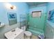 A retro-style bathroom with blue tiled walls, vintage fixtures, and a cozy, nostalgic feel at 2504 Jim Johnson Rd, Plant City, FL 33566