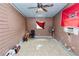Bedroom featuring tile flooring, neutral walls, and a ceiling fan for added comfort at 2504 Jim Johnson Rd, Plant City, FL 33566
