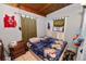 A bedroom featuring a blue flowered comforter, wood ceiling, and window air conditioner at 2504 Jim Johnson Rd, Plant City, FL 33566