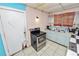 A kitchen featuring a stainless steel stove and vintage-style cabinets, ready for renovation and improvements at 2504 Jim Johnson Rd, Plant City, FL 33566