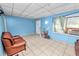 Bright living room featuring tile floors and light blue walls at 2504 Jim Johnson Rd, Plant City, FL 33566