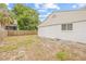 This fenced backyard has a lawn and a concrete pad, and shows the rear of the garage at 3008 W Van Buren Dr, Tampa, FL 33611