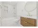 Modern bathroom with sleek bathtub, marble countertops, and gold fixtures at 3008 W Van Buren Dr, Tampa, FL 33611