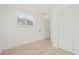 Bright bedroom featuring laminated floors, white walls, and a large closet at 3008 W Van Buren Dr, Tampa, FL 33611