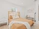 Bright bedroom with a woven headboard, a comfortable bed, hardwood floors, and tasteful decor at 3008 W Van Buren Dr, Tampa, FL 33611