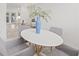 Dining area with a round table surrounded by four chairs, bathed in natural light at 3008 W Van Buren Dr, Tampa, FL 33611