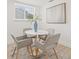 Dining area featuring a round table, modern chairs, and a window with natural light at 3008 W Van Buren Dr, Tampa, FL 33611