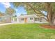This home has nice curb appeal, lush lawn and mature trees at 3008 W Van Buren Dr, Tampa, FL 33611