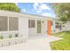 Welcoming home with a well-manicured lawn, fresh paint, and updated landscaping at 3008 W Van Buren Dr, Tampa, FL 33611